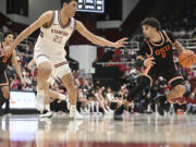 Oregon State guard Jordan Pope (0) is defended by Stanford forward Brandon Angel (23) during the second half of an NCAA college basketball game Saturday, Feb. 24, 2024, in Stanford, Calif.