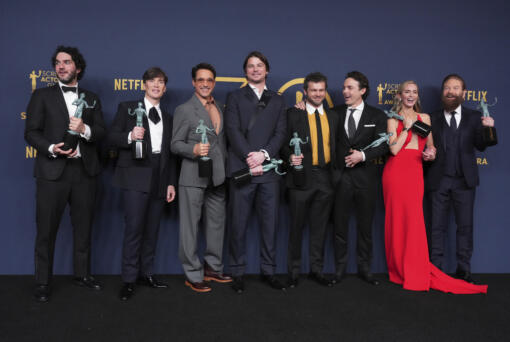 Benny Safdie, from left, Cillian Murphy, Robert Downey Jr., Josh Hartnett, Alden Ehrenreich, Casey Affleck, Emily Blunt, and Kenneth Branagh, winners of the award for the award for outstanding performance by a cast in a motion picture for "Oppenheimer," pose in the press room during the 30th annual Screen Actors Guild Awards on Saturday, Feb. 24, 2024, at the Shrine Auditorium in Los Angeles.