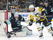 Pittsburgh Penguins center Jeff Carter (77) tries to score against Seattle Kraken goaltender Philipp Grubauer (31) during the second period of an NHL hockey game Thursday, Feb. 29, 2024, in Seattle.