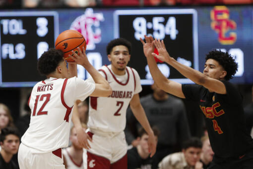 Washington State guard Isaiah Watts (12) prepares to shoot against Southern California guard Oziyah Sellers (4) during the second half of an NCAA college basketball game Thursday, Feb. 29, 2024, in Pullman, Wash. (AP Photo/Young Kwak)