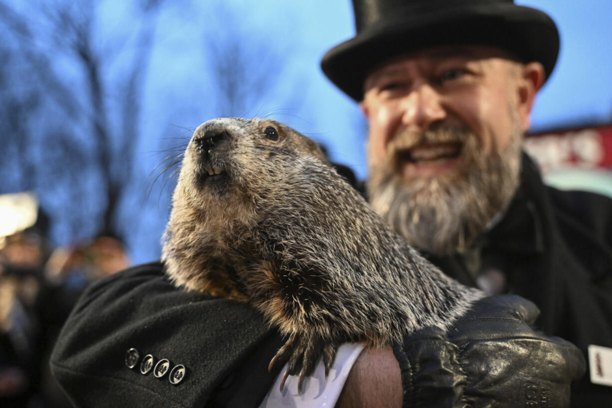 Groundhog Club handler A.J. Dereume holds Punxsutawney Phil, the weather prognosticating groundhog, during the 138th celebration of Groundhog Day on Gobbler&rsquo;s Knob in Punxsutawney, Pa., Friday, Feb. 2, 2024. Phil&rsquo;s handlers said that the groundhog has forecast an early spring.