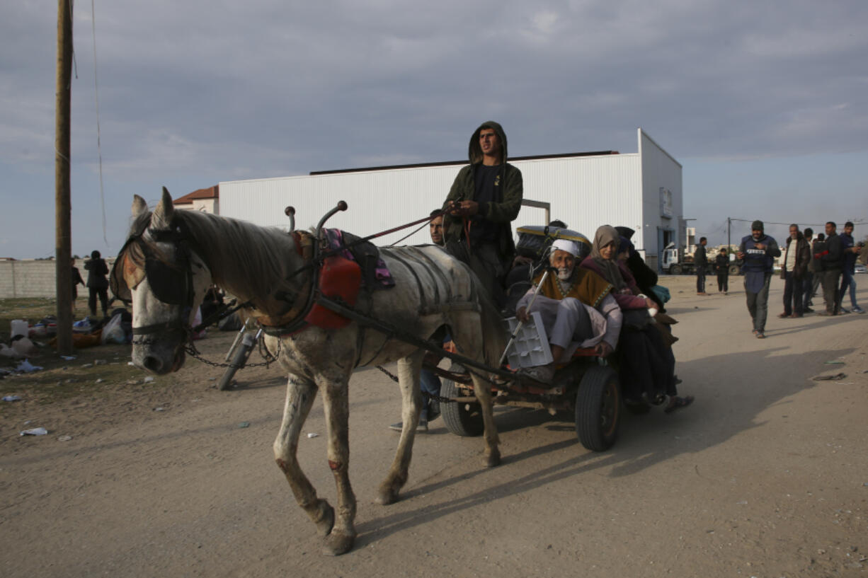 Palestinians fleeing the Israeli offensive on Khan Younis arrive at Rafah, Gaza Strip. Wednesday, Feb. 14, 2024.