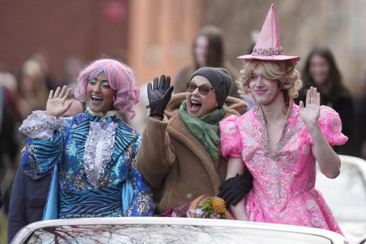 Actor Annette Bening, center, Hasty Pudding 2024 Woman of the Year, rides in a convertible with Harvard University theatrical students Nikita Nair, left, and Joshua Hillers, right, during a parade, Tuesday, Feb. 6, 2024, through Harvard Yard, in Cambridge, Mass. The award was presented to Bening by Hasty Pudding Theatricals, a theatrical student society at Harvard University.