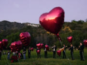 FILE - A Mexican mariachi band surrounded by heart-shaped balloons awaits the arrival of a couple&rsquo;s marriage proposal ceremony at the Lake Hollywood Park in Los Angeles on Valentine&rsquo;s Day, Feb. 14, 2022. In 2024, Feb. 14 is a holiday heavyweight due to a calendar collision of events &mdash; it&rsquo;s Valentine&rsquo;s Day and Ash Wednesday.