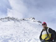 Doug Chabot, with the Gallatin National Forest Avalanche Center, inspects the site of a recent avalanche on Henderson Mountain, Jan. 29, 2024, near Cooke City, Mont. The area has seen numerous fatal avalanches in recent decades but officials say safety efforts are helping keep the rate of accidents from spiking as more people use backcountry areas.