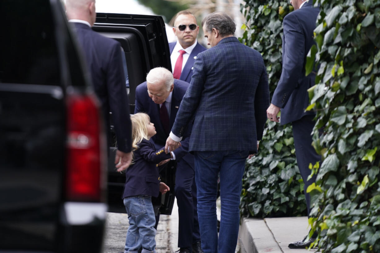 President Joe Biden, center, talks to his grandson Beau, left, as son Hunter Biden, right, looks on after dining at The Ivy in Los Angeles, Sunday, Feb. 4, 2024. Today is Hunter Biden&rsquo;s birthday.