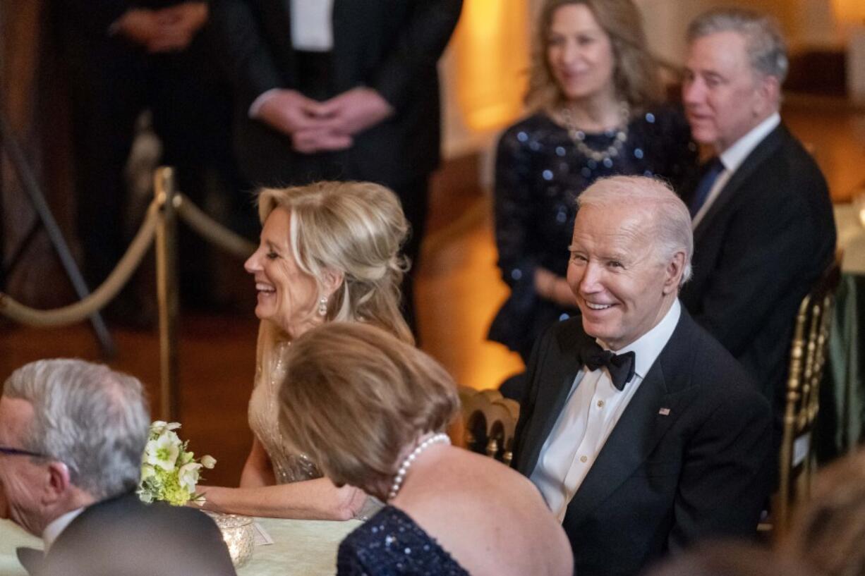 President Joe Biden and first lady Jill Biden laugh during a reception for members of the National Governors Association and their spouses in the East Room of the White House in Washington, Saturday, Feb. 24, 2024.