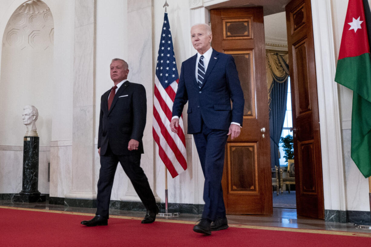 President Joe Biden, right, arrives with Jordan&#039;s King Abdullah II to speak in the Cross Hall of the White House, Monday, Feb. 12, 2024, in Washington.