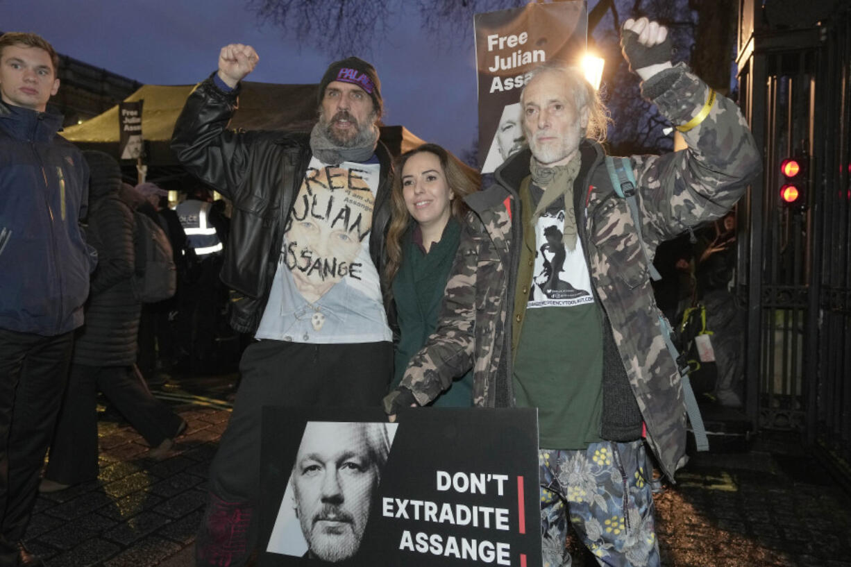 Stella Assange, wife of Julian Assange, centre, poses for a photo with Ben Westwood and Andreas Kronthaler after a march to Downing Street at the end of a two-day hearing at the Royal Courts of Justice in London, Wednesday, Feb. 21, 2024. The 52-year-old WikiLeaks founder Julian Assange has been fighting extradition for more than a decade, including seven years in self-exile in the Ecuadorian Embassy in London and the last five years in a high-security prison.