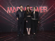 Tahar Rahim, from left, Dakota Johnson and director S.J. Clarkson attend a photo call Jan. 31 for the film &ldquo;Madame Web&rdquo; in London.