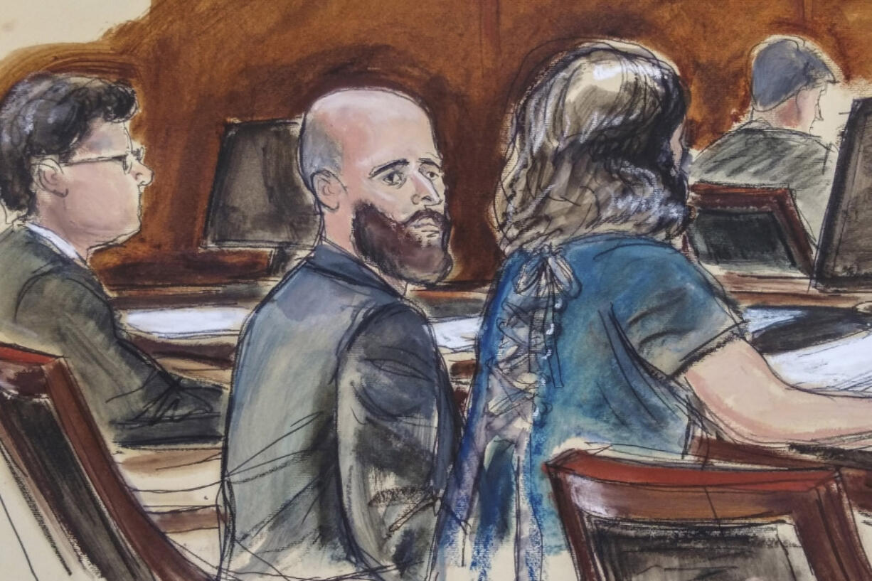 FILE - In this courtroom sketch, Joshua Schulte, center, is seated at the defense table flanked by his attorneys during jury deliberations, March 4, 2020, in New York. Schulte, was sentenced to 40 years in prison, Thursday, Feb. 1, 2024, after his convictions for what the government described as the biggest theft of classified information in CIA history and for possession of child sexual abuse images and videos.