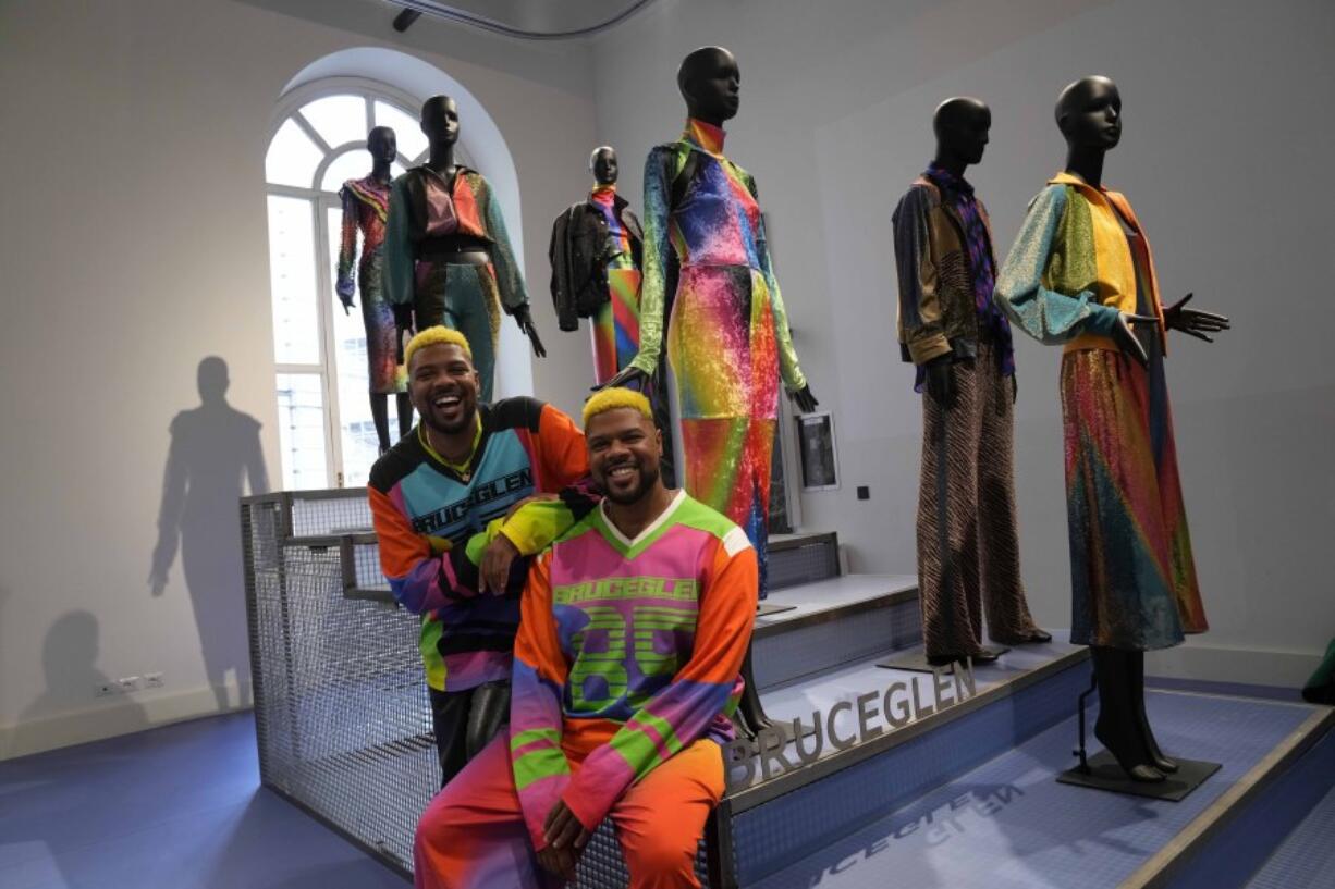 From left, designers Glen and Bruce Proctor sit  Wednesday in front of their creations at the fashion hub part of the women&rsquo;s Fall-Winter 2024-25 collection presented in Milan, northern Italy.
