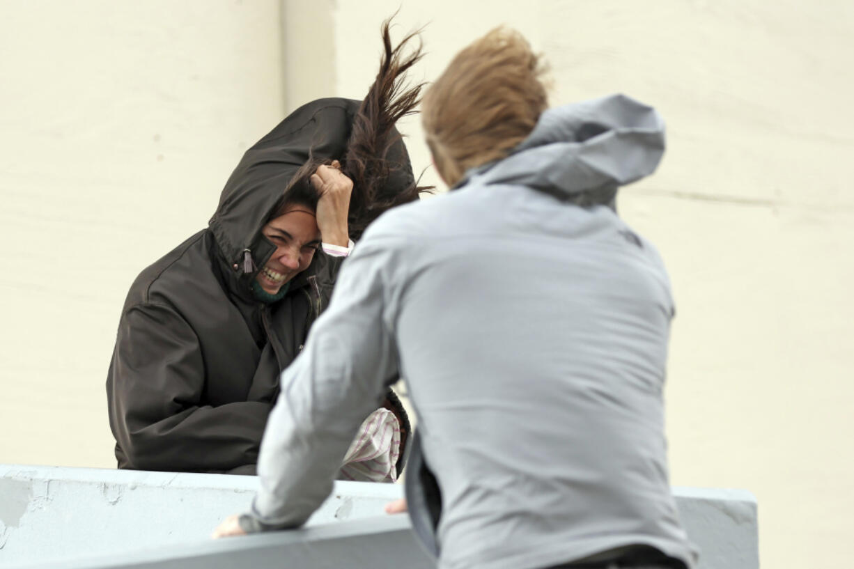 Julia Morelli and Sam Jackson battle the fierce wind gusts along Great Highway in San Francisco on Sunday, Feb. 4, 2024.