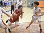 Camas guard Beckett Currie drives against West Valley's Isaiah Currie during a Class 4A state regional boys basketball game on Friday, Feb. 23, 2024 at Davis High School in Yakima.
