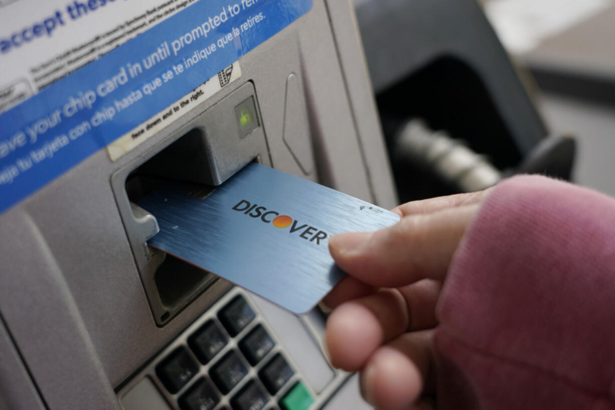 A Discover card is used to pay for gasoline July 1, 2021, at a Sam&rsquo;s Club in Madison, Miss. Capital One Financial is buying Discover Financial Services for $35 billion, in a deal that would bring together two of the nation&rsquo;s biggest lenders and credit card issuers. (Rogelio V.