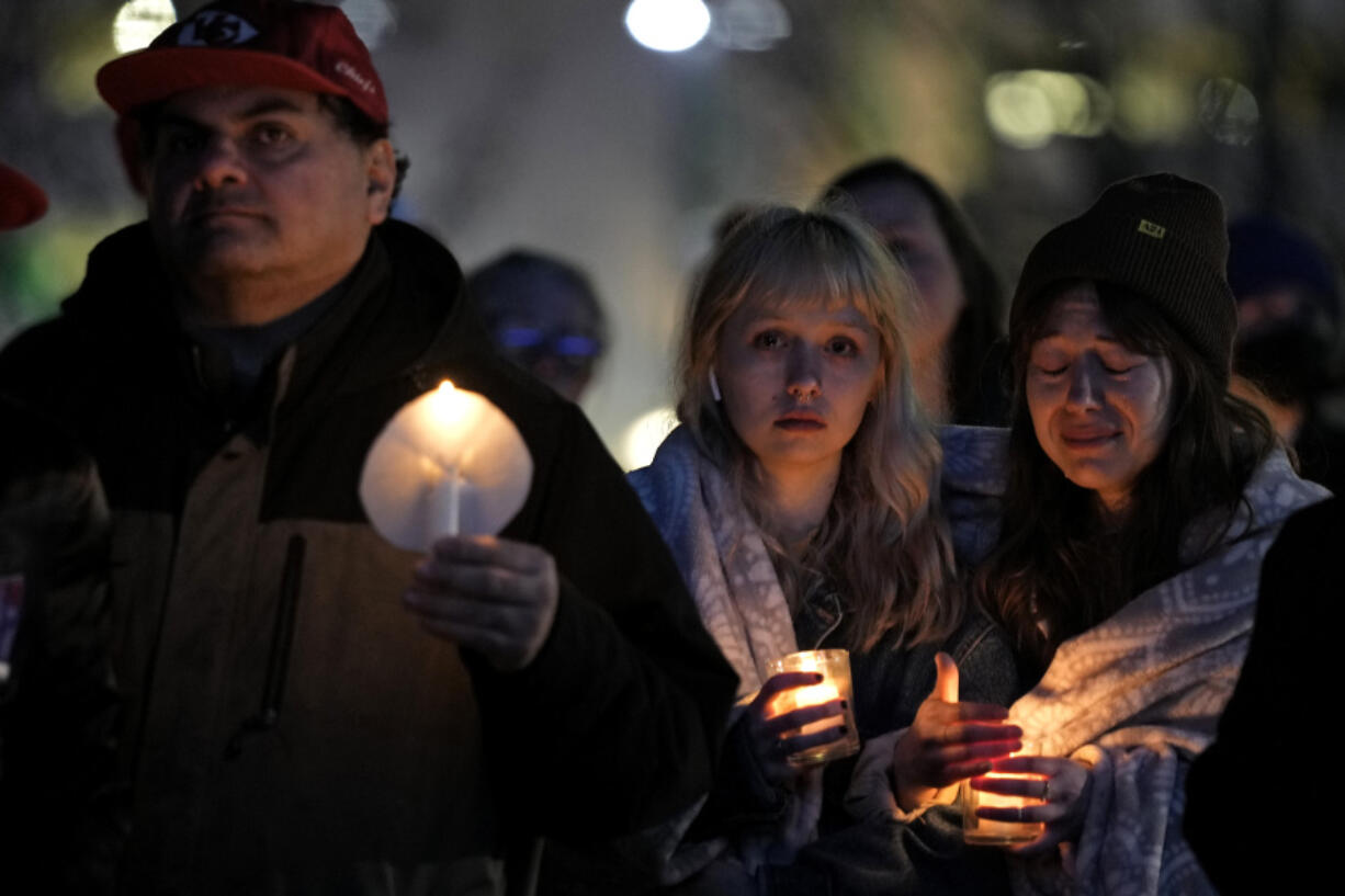 People attend a candlelight vigil for victims of a shooting at a Kansas City Chiefs Super Bowl victory rally Thursday, Feb. 15, 2024 in Kansas City, Mo. More than 20 people were injured and one woman killed in the shooting near the end of Wednesday&rsquo;s rally held at nearby Union Station.