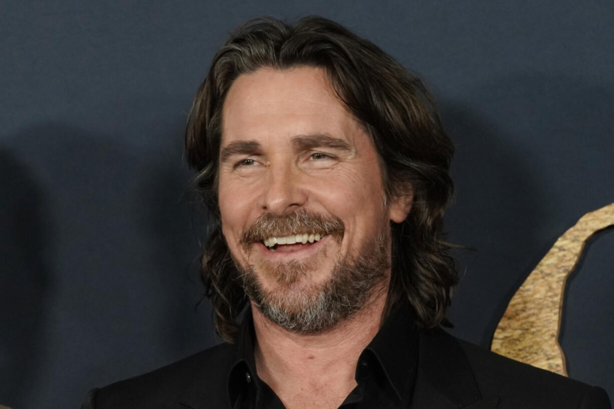 FILE - Christian Bale and cast members in &quot;The Pale Blue Eye,&quot; share a laugh at the premiere of the film, Wednesday, Dec. 14, 2022, at the Directors Guild of America in Los Angeles. Bale has broken ground Wednesday, Feb. 7, 2024, on a project he&rsquo;s been pursuing for 16 years -- the building of a dozen homes and a community center intended to keep siblings in foster care together.