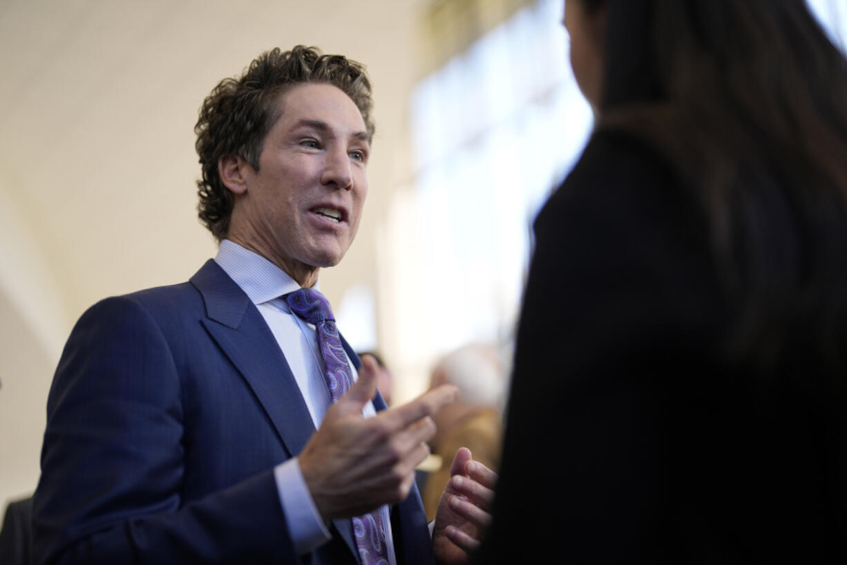 Pastor Joel Osteen talks with reporters after a service, Sunday, Feb. 18, 2024, in Houston. Pastor Osteen welcomed worshippers back to Lakewood Church for the first time since a woman with an AR-style opened fire in between services at his Texas megachurch last Sunday. (AP Photo/David J.