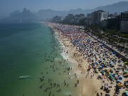 FILE - Beachgoers flock to Ipanema beach to beat the extreme heat in Rio de Janeiro, Brazil, Sept. 24, 2023.