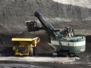 FILE - A mechanized shovel loads a haul truck that can carry up to 250 tons of coal at the Spring Creek coal mine, April 4, 2013, near Decker, Mont. On Wednesday, Feb. 21, 2024, a U.S. appeals court struck down a judge&rsquo;s 2022 order that imposed a moratorium on coal leasing from federal lands.