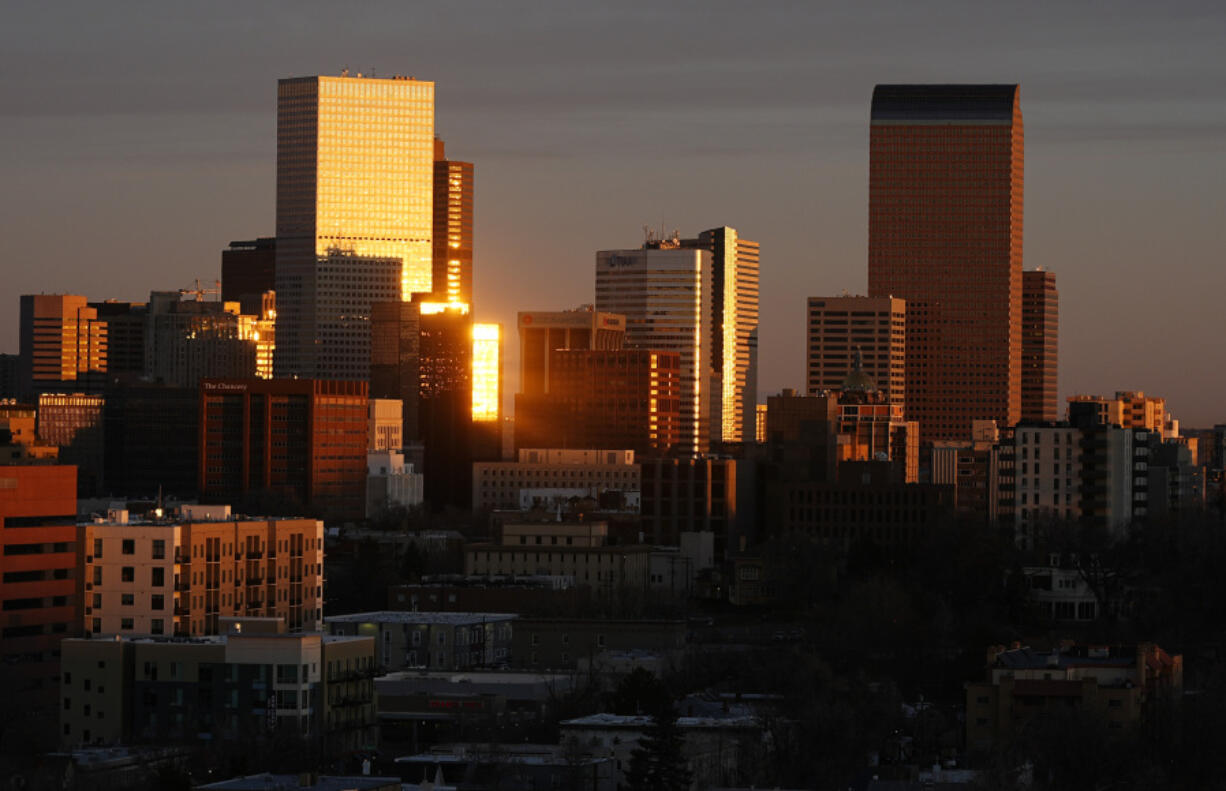 The rising sun illuminates the skyline early Tuesday, Feb. 20, 2024, in Denver. Forecasters predict high temperatures in the mid-60s in the Mile High City Tuesday as a warm front moves in from the Pacific to envelop the Centennial State.