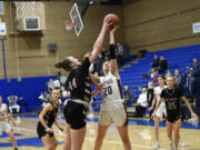 Julia Dalan (44) of W.F. West blocks the shot of Emma Iniguez of Columbia River in the 2A girls basketball district championship game at Kelso High School on Friday, Feb. 16, 2024.