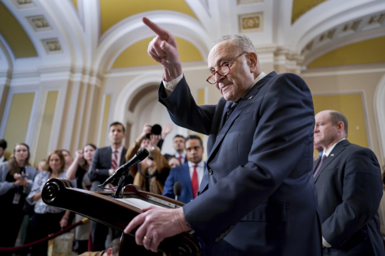 Senate Majority Leader Chuck Schumer, D-N.Y., answers questions on the border security talks as he meets reporters following a Democratic caucus meeting, at the Capitol in Washington, Wednesday, Jan. 31, 2024. (AP Photo/J.