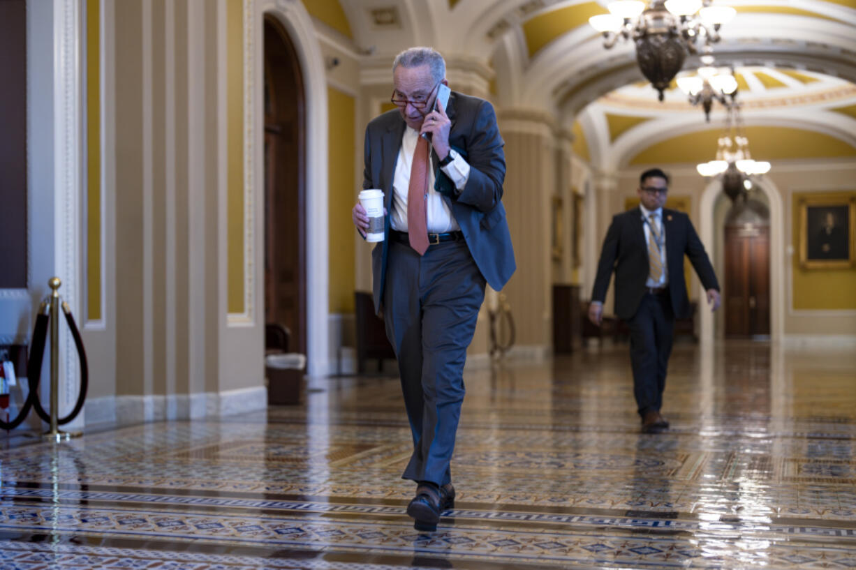 Senate Majority Leader Chuck Schumer, D-N.Y., arrives while Republicans hold a closed-door meeting after blocking a bipartisan border package that had been tied to wartime aid for Ukraine, at the Capitol in Washington, Thursday. (AP Photo/J.