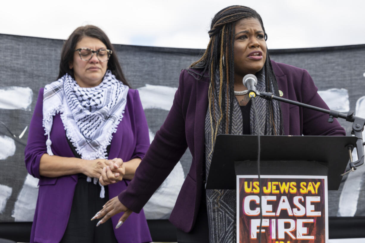 FILE - Rep. Cori Bush, D-Mo., speaks as Rep. Rashida Tlaib, D-Mich., listens during a demonstration calling for a ceasefire in Gaza near the Capitol in Washington, Oct. 18, 2023. A group of progressive lawmakers are fighting back against a multi-million dollar campaign to push them out of Congress for their vocal opposition to Israel&rsquo;s deadly bombardment of Gaza after the Oct. 7 attack.