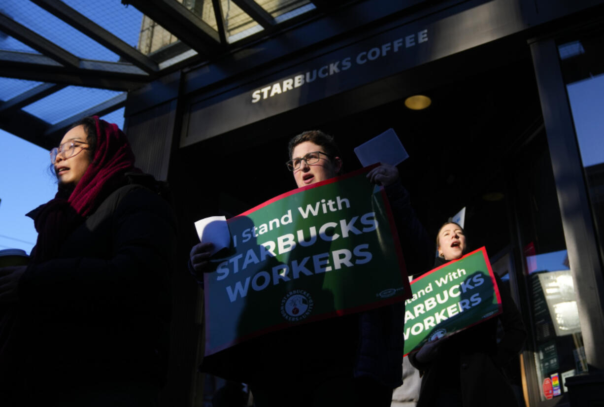 File - Starbucks workers and allies participate in a strike and picket organized by Starbucks Workers United during the company&rsquo;s Red Cup Day, Nov. 16, 2023, near Pike Place Market in Seattle. Starbucks on Tuesday reported record revenue in its fiscal first quarter but the results fell short of Wall Street&rsquo;s expectations as customer spending slowed in some key markets.