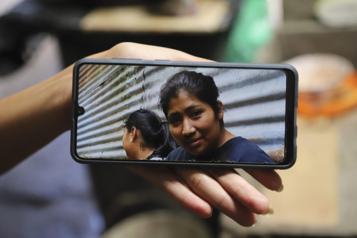 A family member shows a phone photo of Juana Guadalupe Recinos, who was detained last year during the government&rsquo;s crackdown on its war against drugs, in Santa Ana, El Salvador, Wednesday, Jan. 31, 2024. Police detained Recinos on a charge of &ldquo;illegal gathering&rdquo; as she walked to work leaving her two sons motherless for more than a year.