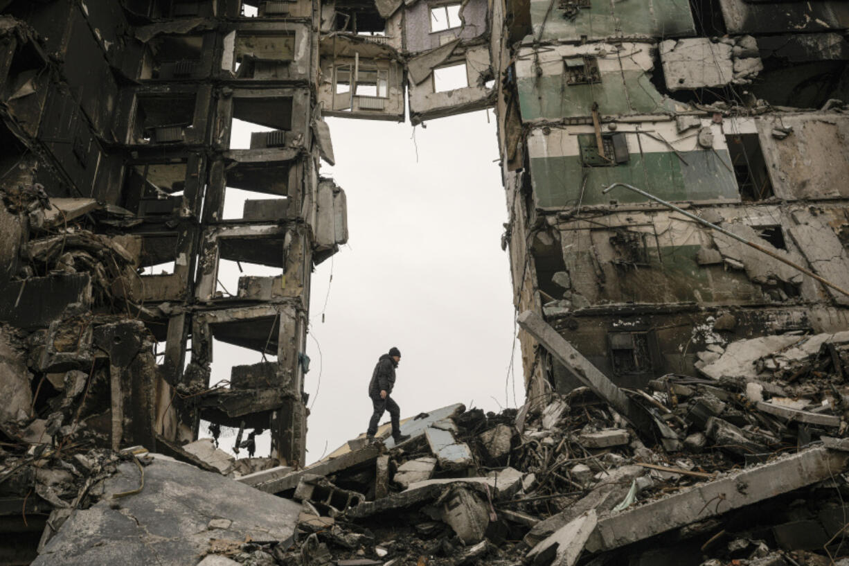 FILE - A resident looks for belongings in an apartment building destroyed during fighting between Ukrainian and Russian forces in Borodyanka, Ukraine, April 5, 2022. The GOP has been softening its stance on Russia ever since Donald Trump won the 2016 presidential election following Russian hacking of his Democratic opponents. The reasons include Russian President Vladimir Putin holding himself out as an international champion of conservative Christian values, the GOP&rsquo;s growing skepticism of international entanglements and Trump&rsquo;s own personal embrace of the Russian leader. Now the GOP&rsquo;s ambivalence on Russia has stalled additional aid to Ukraine.