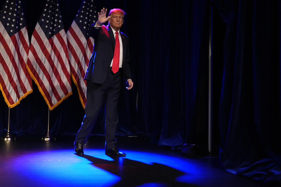Republican presidential candidate former President Donald Trump waves after speaking at a caucus night rally in Las Vegas, Thursday, Feb. 8, 2024.