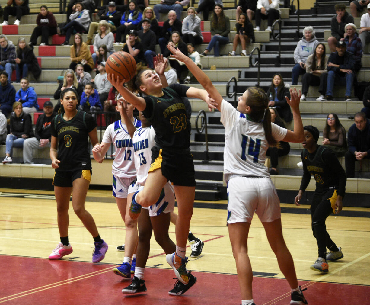 Adrian Wright of Evergreen takes a shot against Sophia Wright (14) of Mountain View in a 3A Greater St. Helens League tiebreaker girls basketball game at Camas High School on Tuesday, Feb. 6, 2024.