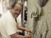 FILE - Sculptor and former astronaut Ed Dwight works on a piece in his studio in Denver, Colo., on Aug. 5, 1999. Dwight is featured in a documentary &ldquo;The Space Race,&rdquo; which chronicles the stories of Black astronauts.