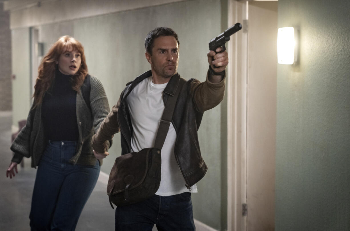 This image released by Apple shows Bryce Dallas Howard, left, and Sam Rockwell in a scene from &ldquo;Argylle.&rdquo; (Peter Mountain/Apple-Universal Pictures via AP)