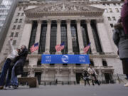 Tourists pose for photographs outside of the New York Stock Exchange, Tuesday, Feb. 27, 2024, in New York.