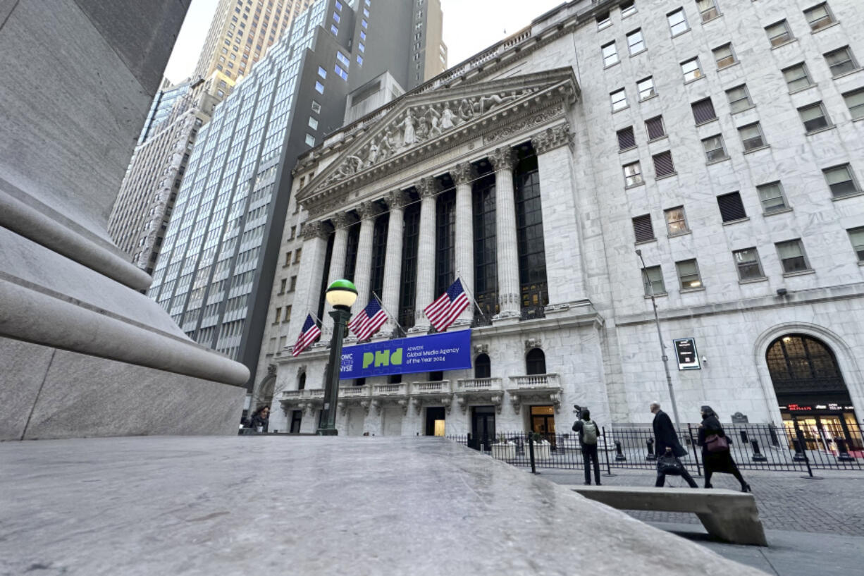 Pedestrians pass the New York Stock Exchange on Tuesday, Feb. 20, 2024 in New York.