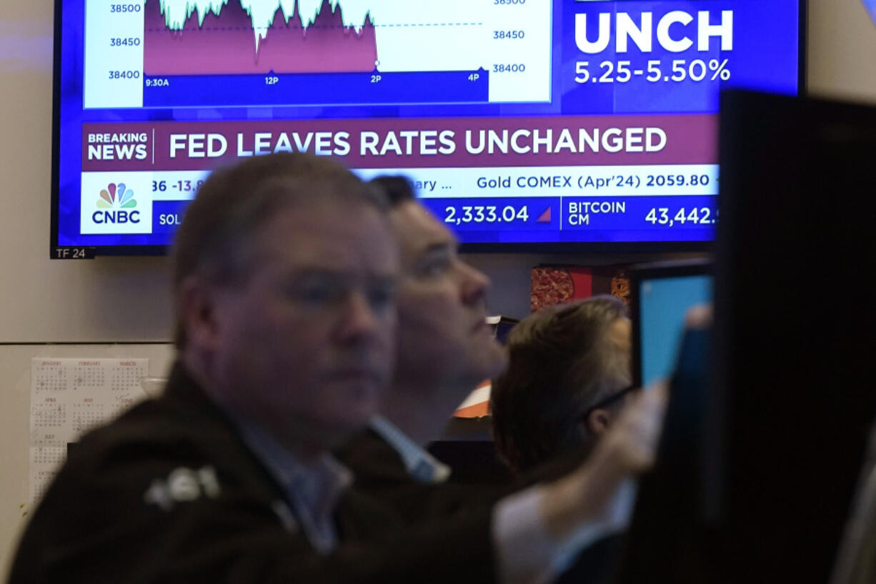 A television screen on the floor of the New York Stock Exchange displays the Federal Reserve&rsquo;s decision on interest rates, Wednesday, Jan. 31, 2024. The Fed kept its key rate unchanged at about 5.4%, a 22-year high. In a statement, it signaled a policy shift by dropping previous wording that had said it was still considering further rate hikes.