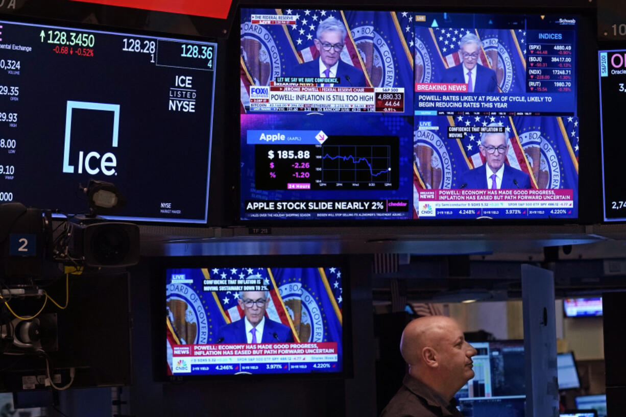 Television screens on the floor of the New York Stock Exchange show the news conference of Federal Reserve Chair Jerome Powell, Wednesday, Jan. 31, 2024. The Fed kept its key rate unchanged at about 5.4%, a 22-year high. In a statement, it signaled a policy shift by dropping previous wording that had said it was still considering further rate hikes.