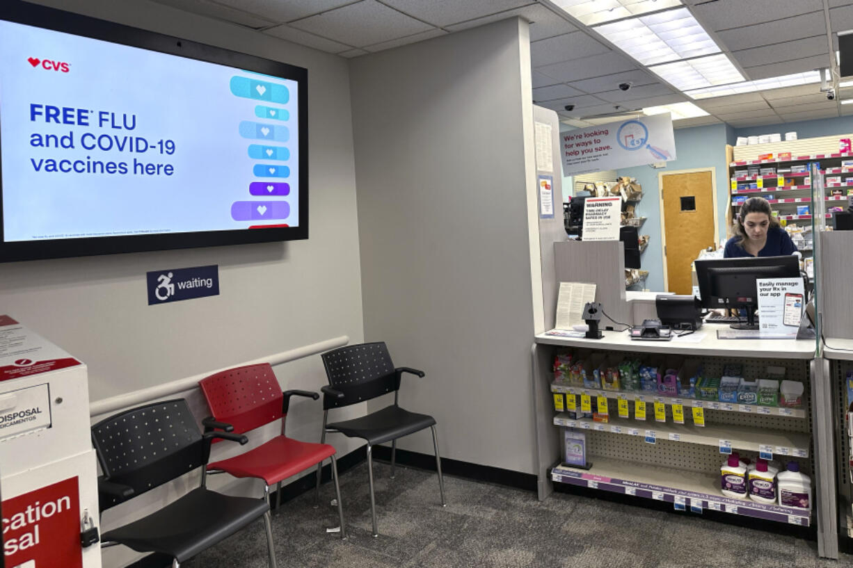 FILE - A sign for flu vaccination is displayed on a screen at a pharmacy store in Buffalo Grove, Ill., Tuesday, Feb. 13, 2024. Early estimates suggest flu shots are performing OK in the current U.S. winter flu season. The vaccines were around 40% effective in preventing adults from getting sick enough from the flu that they had to go to a doctor&rsquo;s office, clinic or hospital, health officials said during a Centers for Disease Control and Prevention vaccines meeting Wednesday, Feb. 28, 2024. (AP Photo/Nam Y.