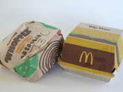 FILE - A Burger King Whopper in a wrapper, left, rests next to a McDonald&#039;s Big Mac in a container, in Walpole, Mass., Wednesday, April 20, 2022. Food wrappers and packaging that contain &ldquo;forever chemicals&rdquo; that can harm human health are no longer being sold in the U.S., the Food and Drug Administration announced Wednesday, Feb. 28, 2024.