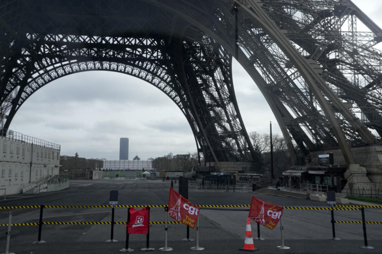 Unions flags are pictured at the Eiffel Tower, Tuesday, Feb. 20, 2024 in Paris. Visitors to the Eiffel Tower were turned away for the second consecutive day because of a strike over poor financial management at one of the world&rsquo;s most-visited sites.
