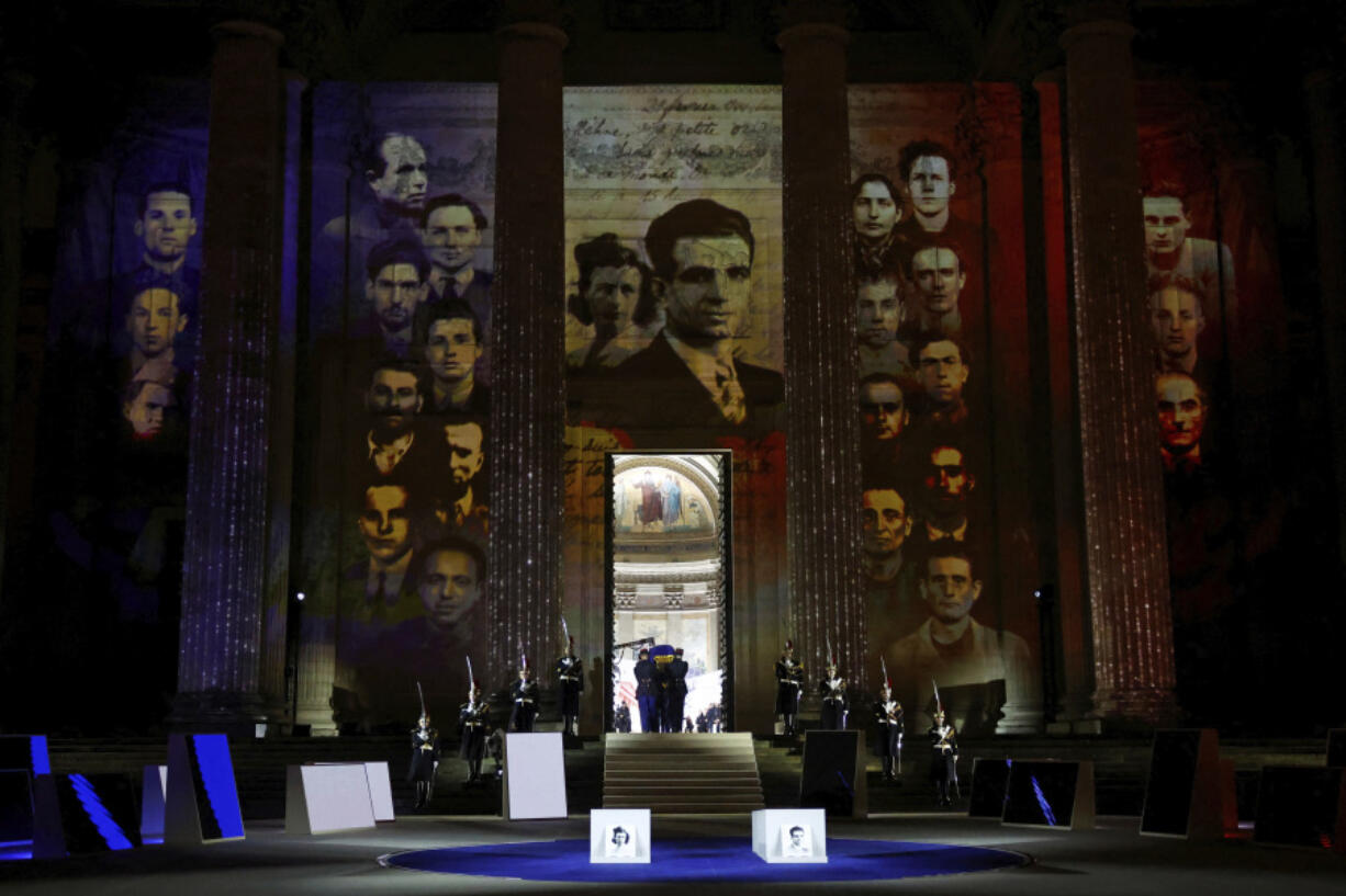 The coffin of Missak Manouchian, carried by Republican Guards, enters the Pantheon monument for his induction ceremony and for his 23 resistance fighters, Wednesday, Feb 21, 2024 in Paris. A poet and communist fighter who took refuge in France after surviving the Armenian genocide, Manouchian was executed in 1944 for leading the resistance to Nazi occupation.