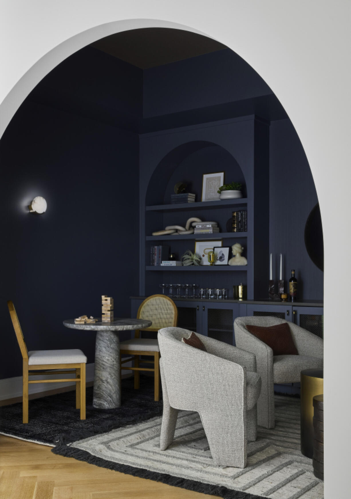 In a modern boho home located in New Buffalo Michigan, DGI created a cool cozy alcove; the inky blue hue accentuates the curved ceiling and intimate space.