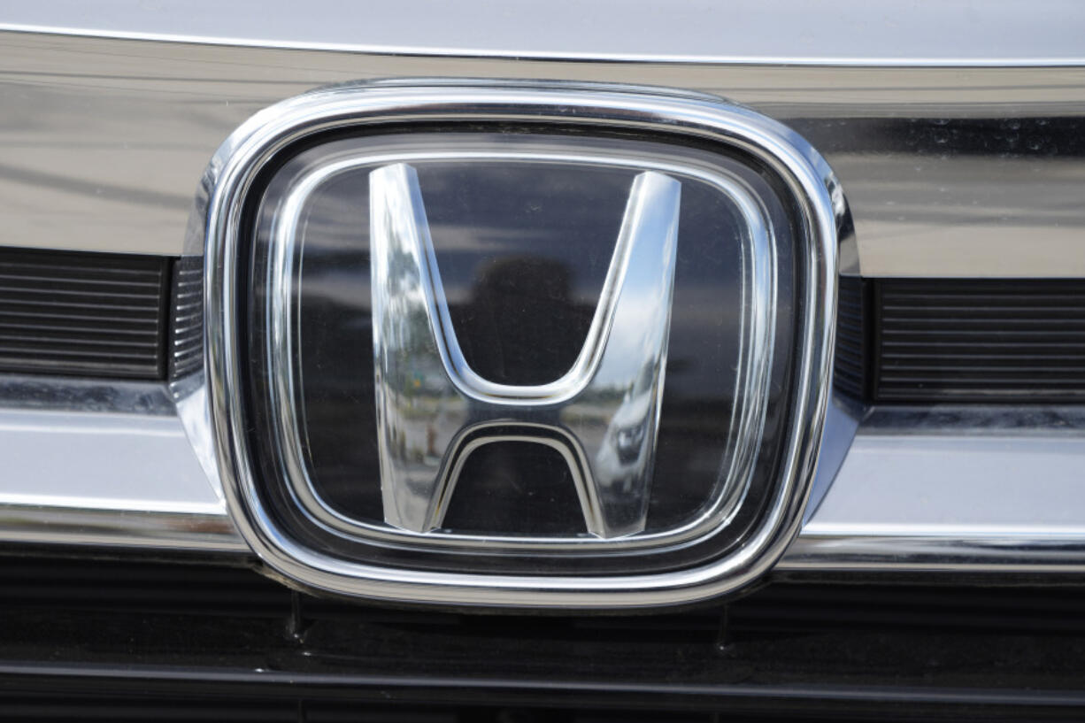 FILE - The Honda company logo is shown outside a Honda dealership Sunday, Sept. 12, 2021, in Highlands Ranch, Colo. Honda is recalling more than three quarters of a million vehicles in the U.S. because a faulty sensor may cause the front passenger air bags to inflate when they&rsquo;re not supposed to.