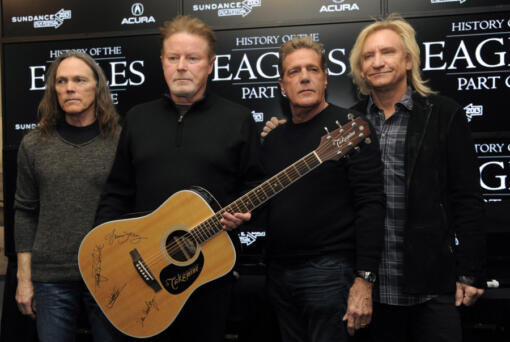 FILE - Members of The Eagles, from left, Timothy B. Schmit, Don Henley, Glenn Frey and Joe Walsh pose with an autographed guitar after a news conference at the Sundance Film Festival, Jan. 19, 2013, in Park City, Utah. On Wednesday, Feb.
