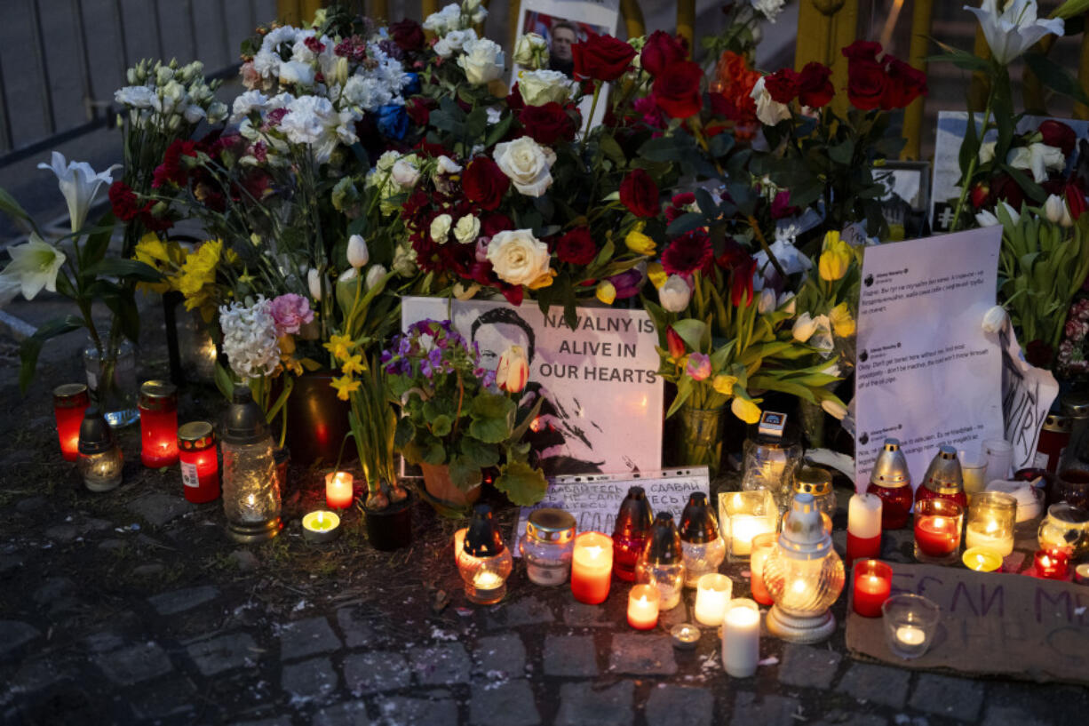 Flower and a pictures are left as a tribute to Russian opposition leader Alexei Navalny, near to the Russian Embassy in Budapest, Hungary, Saturday, Feb. 24, 2024.