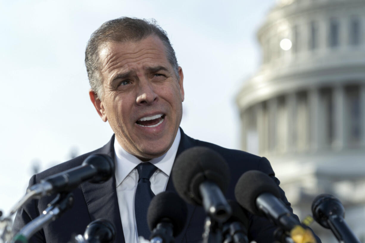 FILE - Hunter Biden, son of President Joe Biden, talks to reporters at the U.S. Capitol, in Washington, Dec. 13, 2023. An FBI informant has been charged with lying to his handler about ties between Joe Biden and son Hunter and a Ukrainian energy company. Prosecutors said Thursday that Alexander Smirnov falsely told FBI agents in June 2020 that executives associated with the Ukrainian energy company Burisma paid Hunter and Joe Biden $5 million each in 2015 and 2016.(AP Photo/Jose Luis Magana.