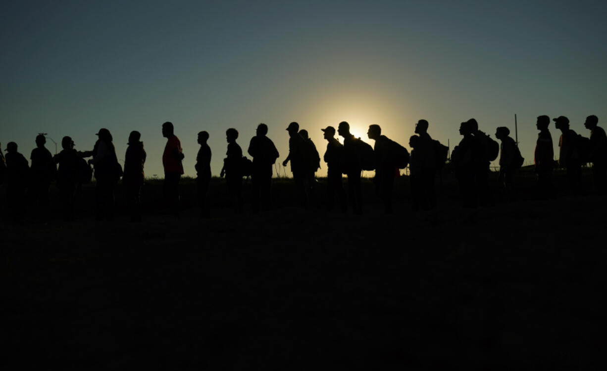 FILE - Migrants who crossed the Rio Grande and entered the U.S. from Mexico are lined up for processing by U.S. Customs and Border Protection, Sept. 23, 2023, in Eagle Pass, Texas. A federal judge on Thursday, Feb. 29, 2024 blocked a new Texas law that gives police broad powers to arrest migrants suspected of illegally entering the U.S., dealing a victory to the Biden administration in its feud with Republican Gov. Greg Abbott over immigration enforcement.